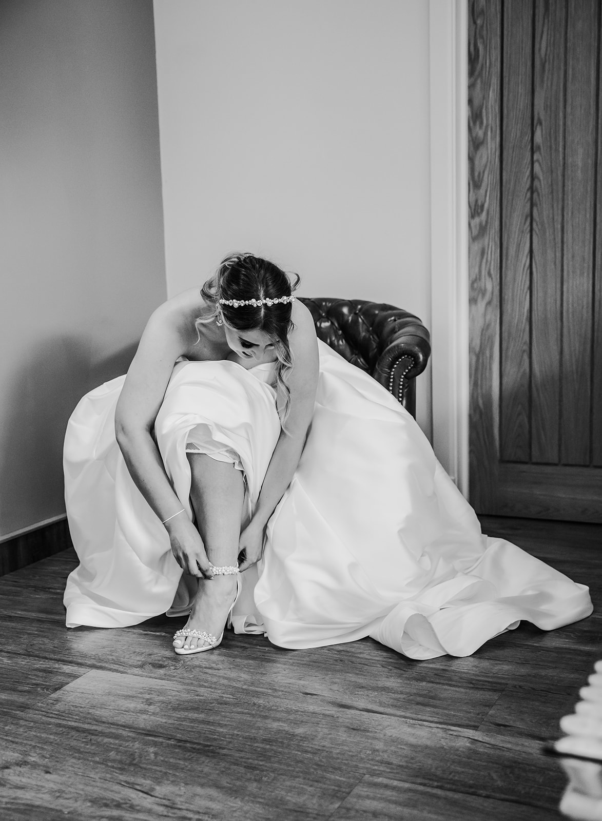 Bride getting ready in her wedding dress at Bredenbury Court barns