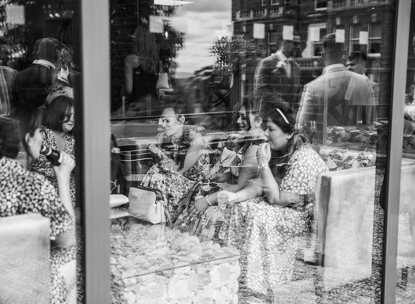 Bredenbury Court Barns reflection of wedding guests in window black and white creative photograph