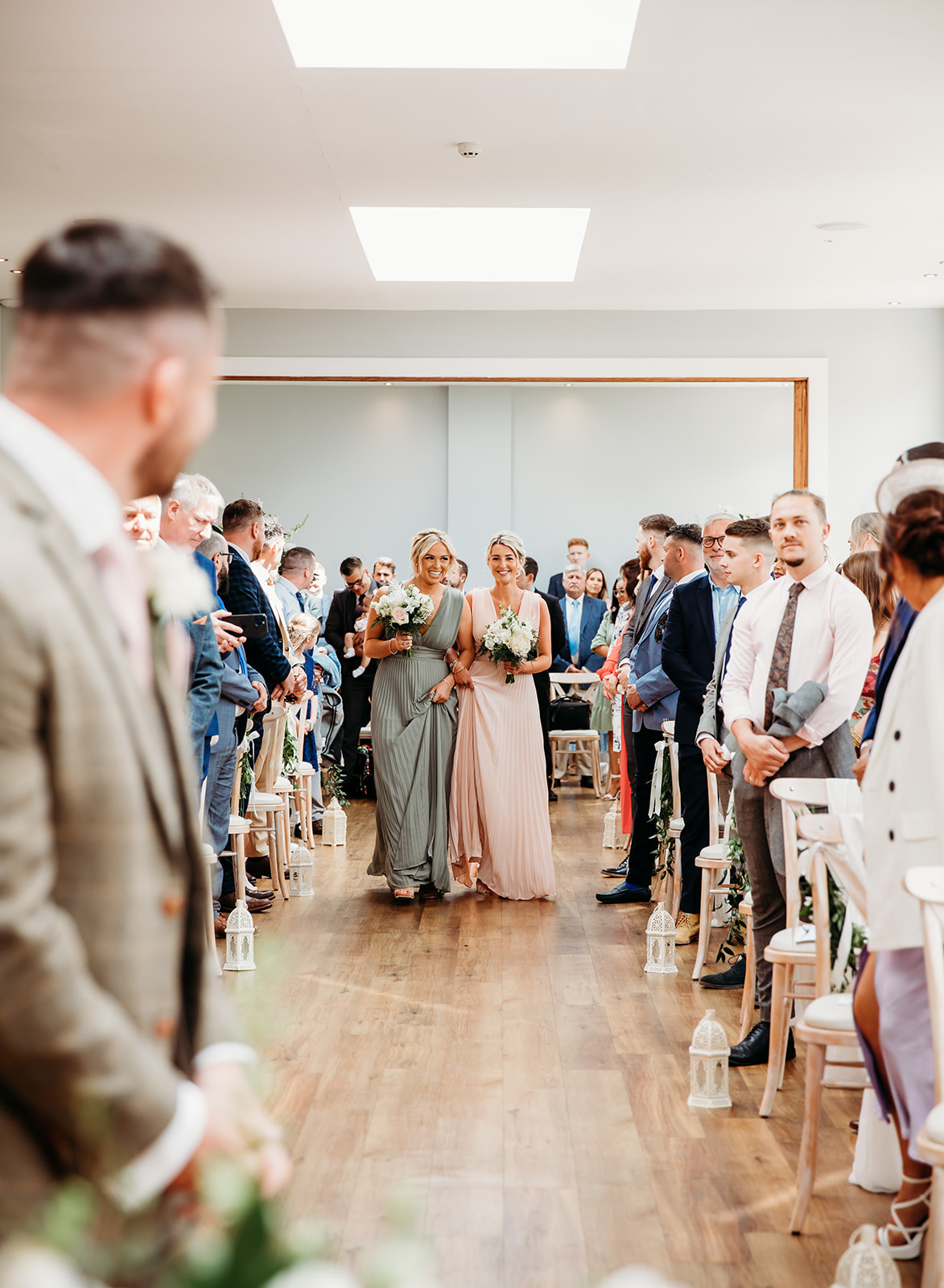 Bridesmaids walking down the aisle at Bredenbury Court Barns wedding ceremony