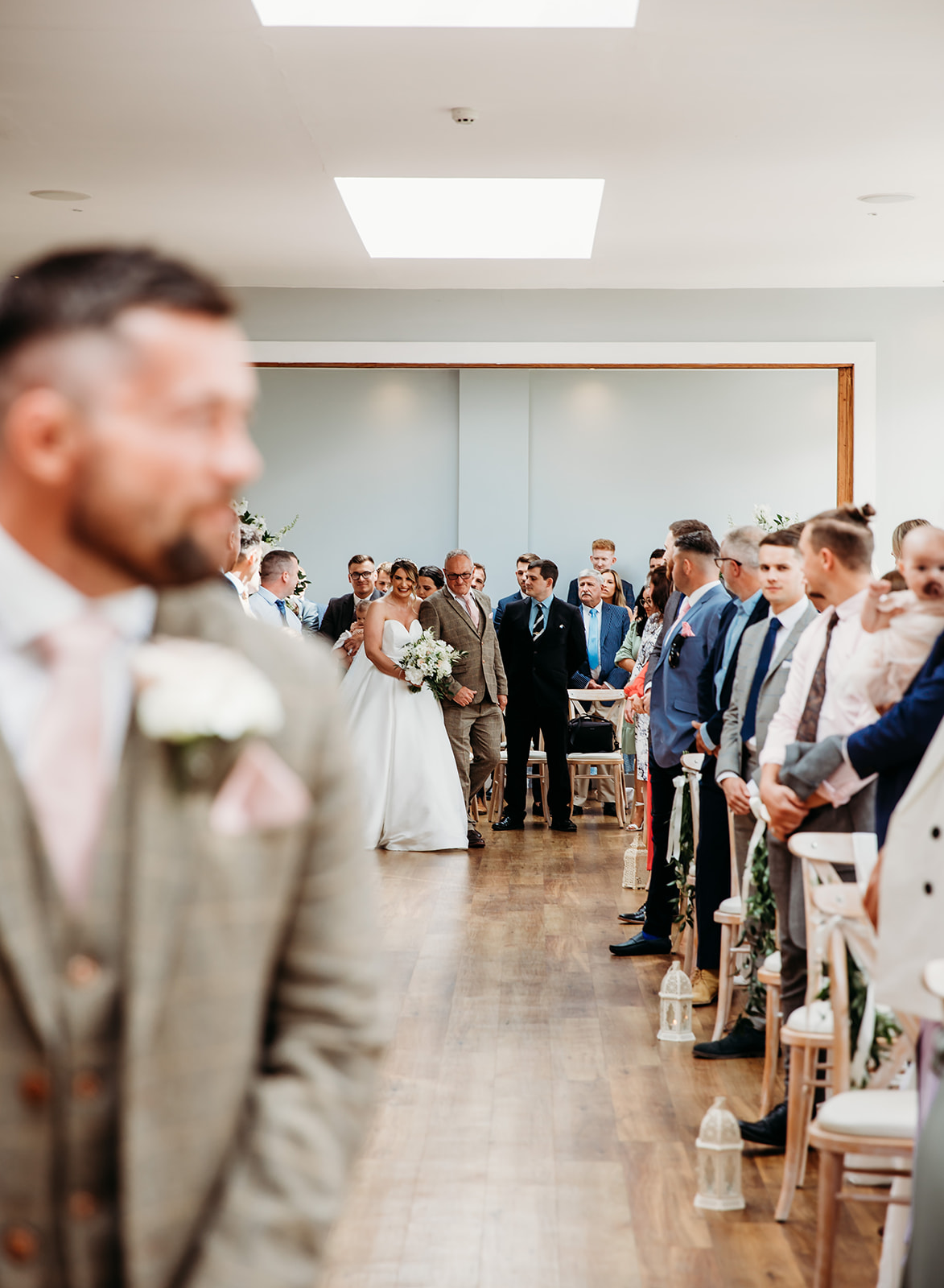Groom waiting for bride to walk down the aisle at Bredenbury Court Barns ceremony