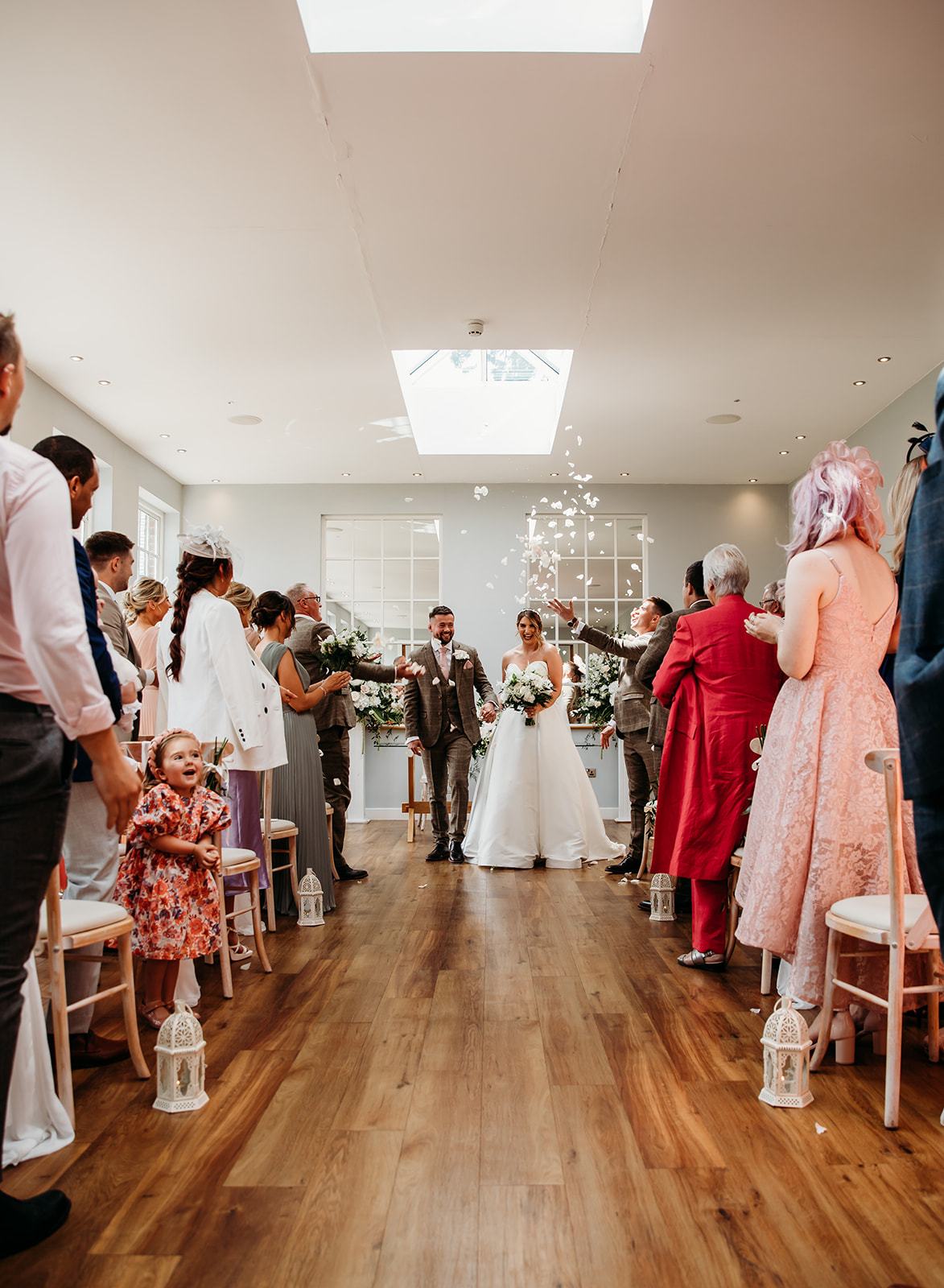 Bride and Groom walking down the aisle at Bredenbury Court Barns indoor wedding ceremony
