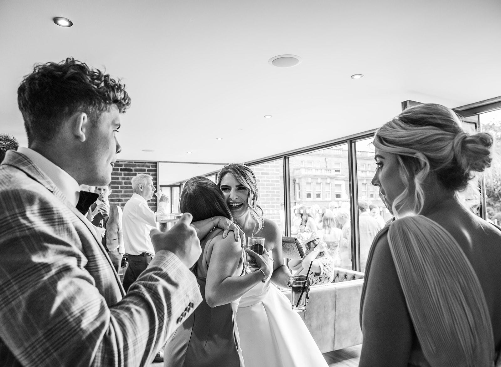 Bride embraces friends at bredenbury court barns wedding reception