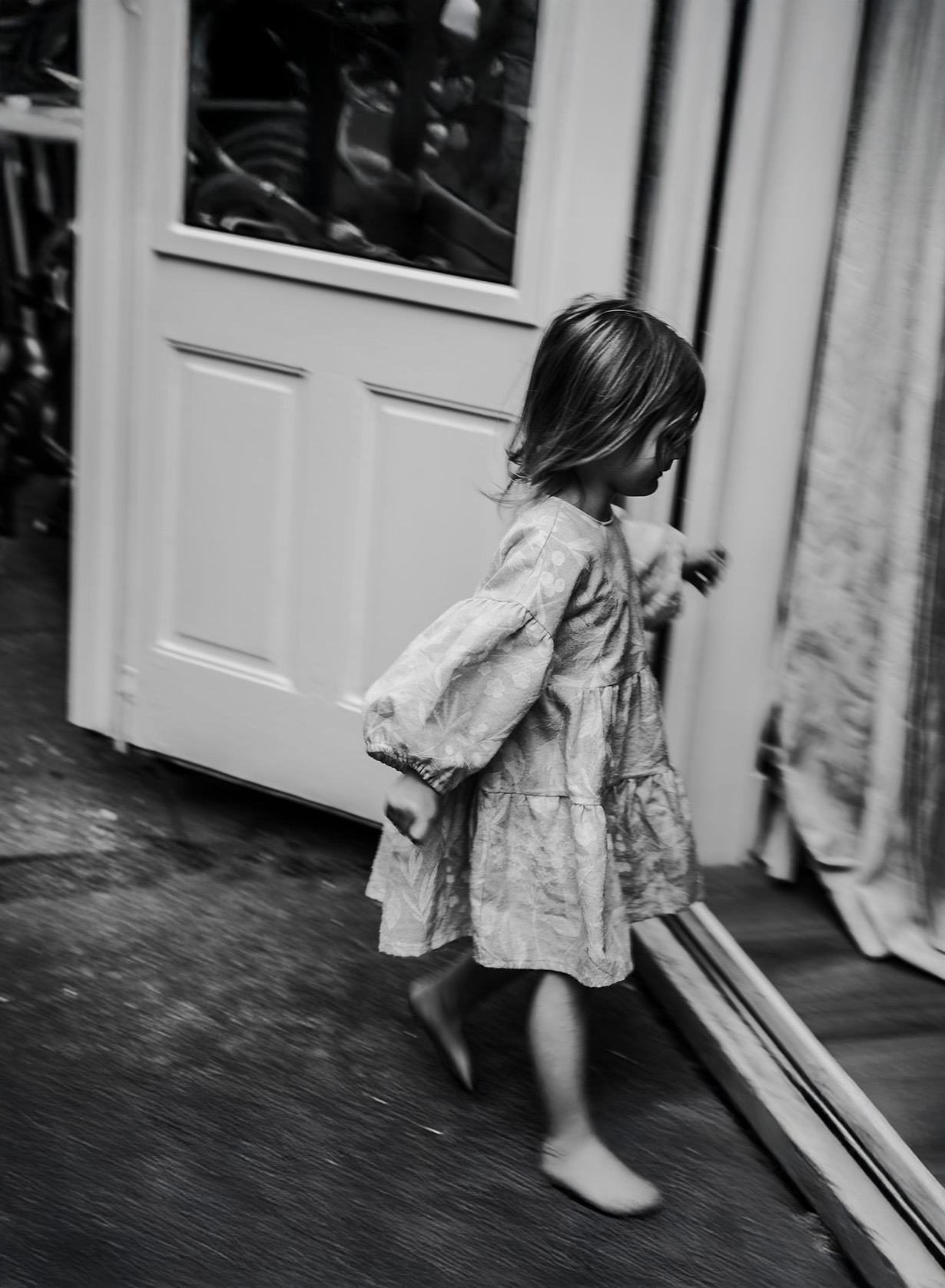 candid brand photo in cheltenham of child running, black and white storytelling imagery