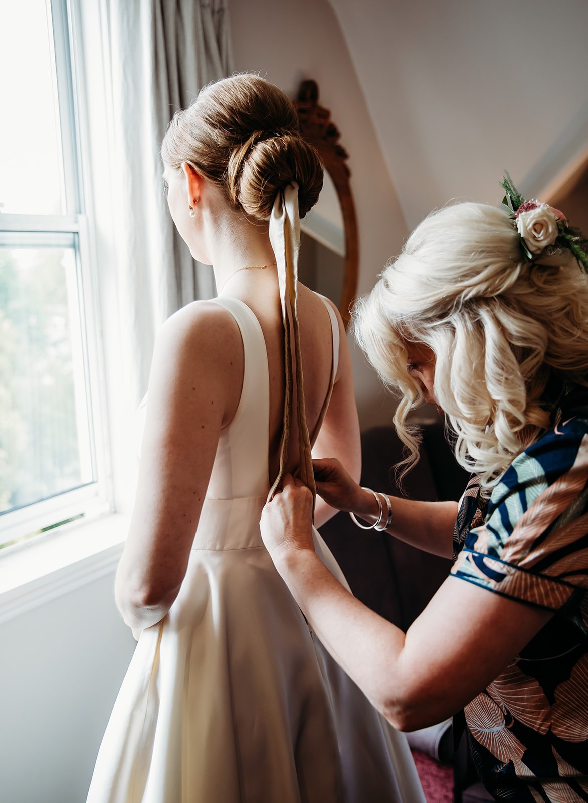 Bride getting ready in her wedding dress in Cheltenham
