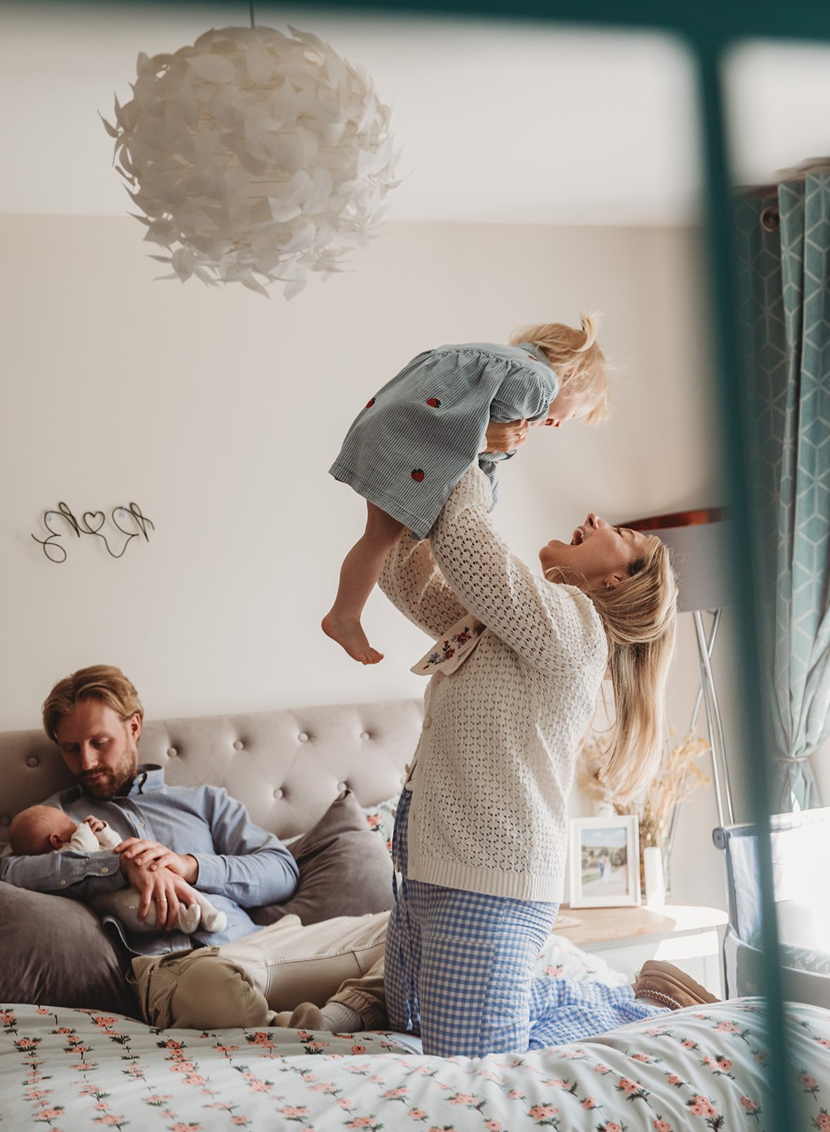 happy candid family photo with newborn baby and sibling